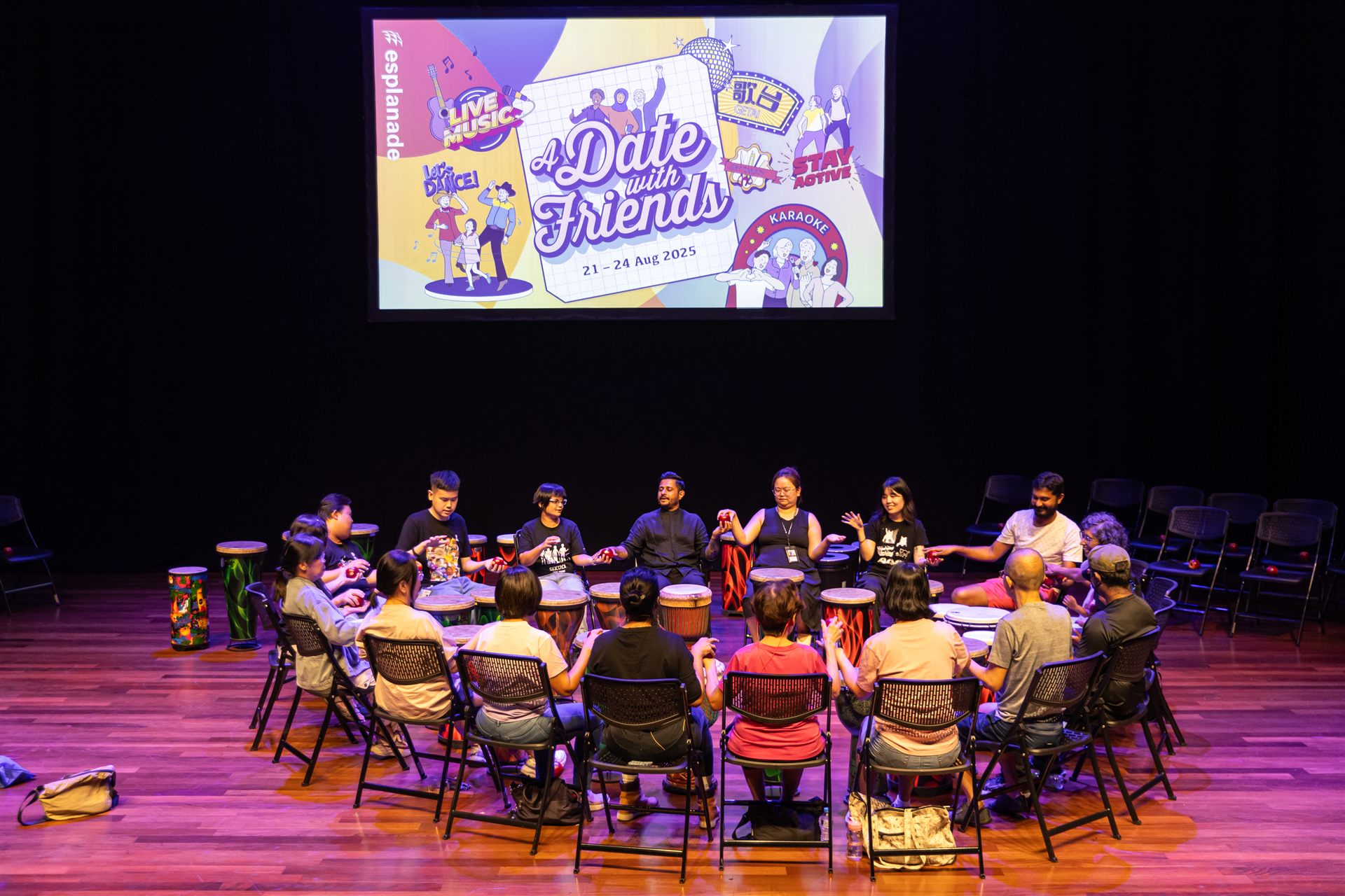 A wide view of a Golden Grooves drum circle on stage at the Esplanade
