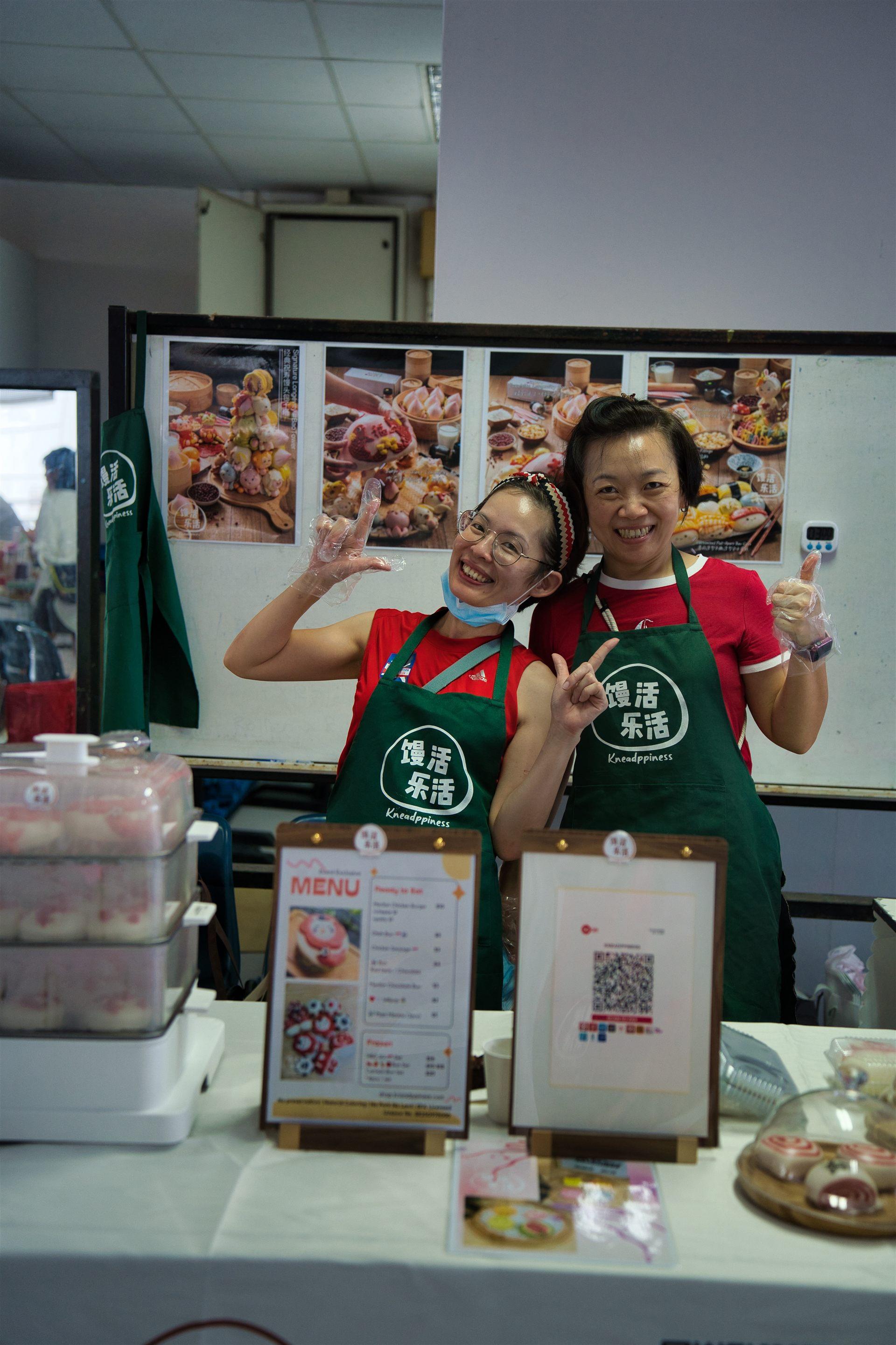 Smiling food stall volunteers having fun at the carnival