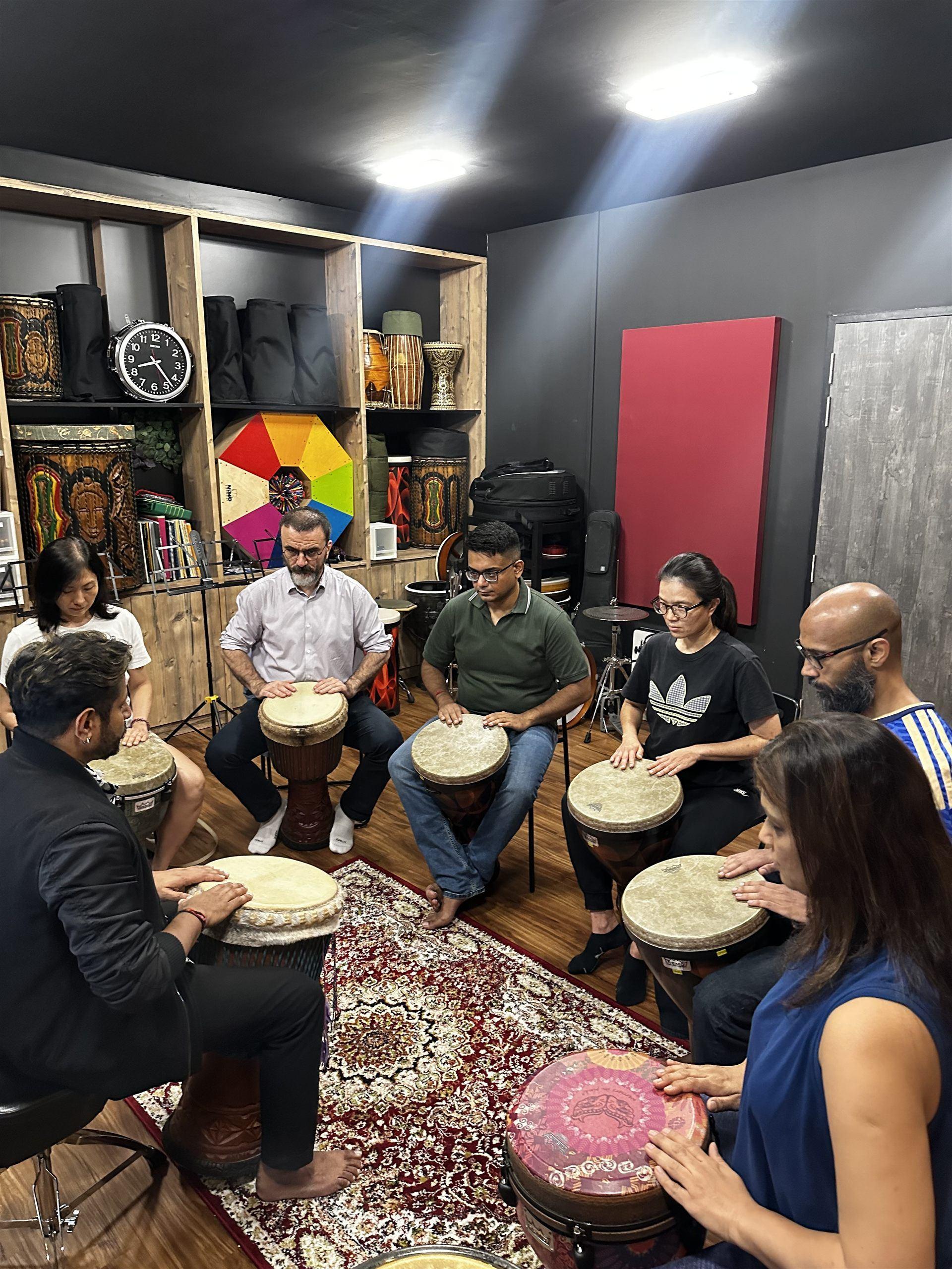 A group percussion circle session with djembe drums