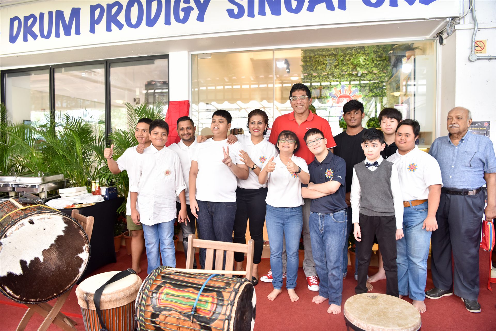 The Drum Prodigy Singapore team celebrating outside the new Hougang studio